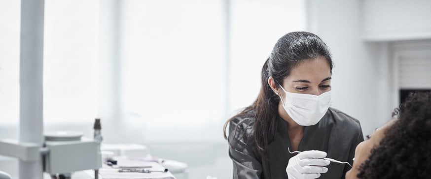 female-dentist-examining-patient