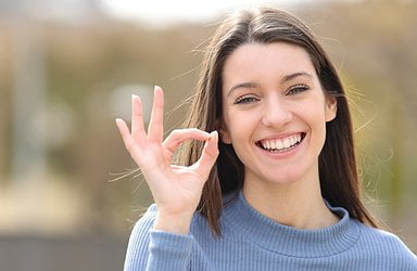 happy-teen-gesturing-ok-sign