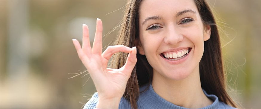happy-teen-gesturing-ok-sign
