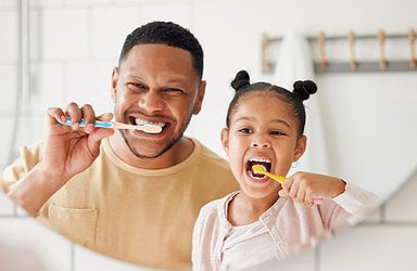 father-and-daughter-brushing-their-teeth